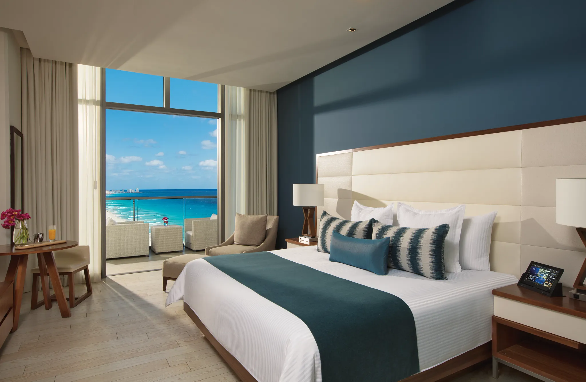 Deluxe Partial Ocean View room with king bed and private balcony overlooking the Caribbean at Secrets The Vine Cancun.