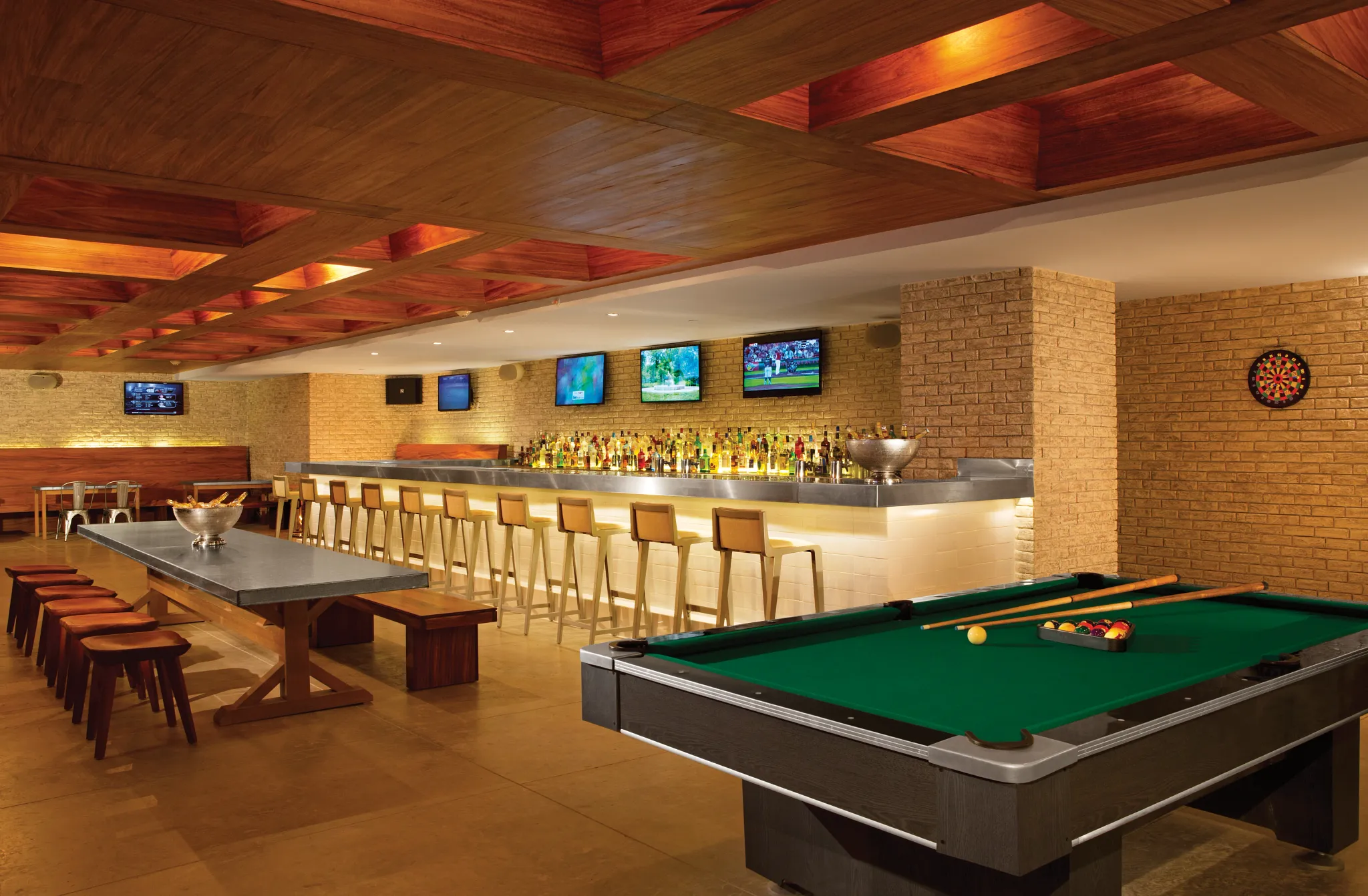 Half Time Sports Bar at Secrets The Vine Cancun featuring flat-screen TVs, casual seating, and a lively atmosphere with drinks and bar snacks.