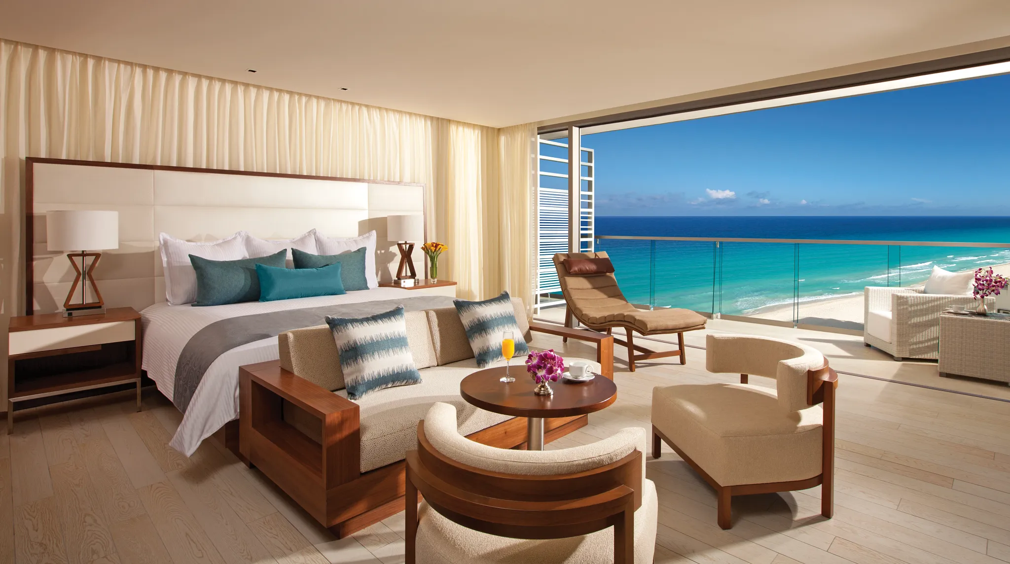 Preferred Club Junior Suite Ocean View with king bed and separate sitting area at Secrets The Vine Cancun.