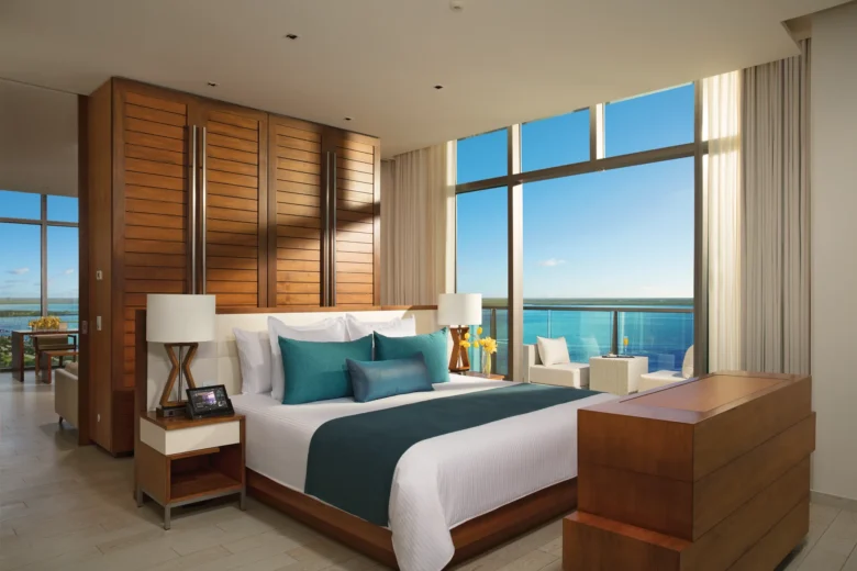 Preferred Club Master Suite Ocean View bedroom with king bed and private balcony overlooking the ocean at Secrets The Vine Cancun.
