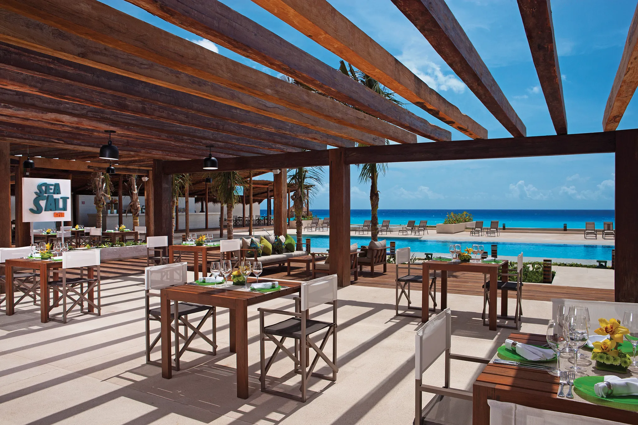 Sea Salt Grill at Secrets The Vine Cancun featuring a stylish seaside dining setting with fresh seafood and Peruvian-inspired cuisine.