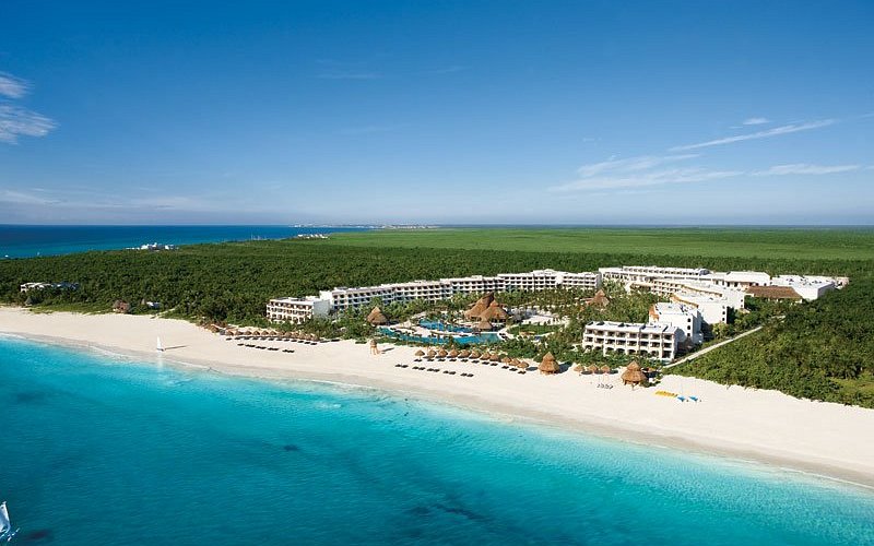 Secrets Maroma Beach Riviera Cancun adults-only luxury resort with tropical beachfront and palm-lined pools.